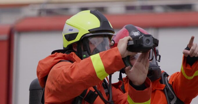 A group of specialized firefighters employs a thermal camera to locate and assess dangerous fire areas, demonstrating their advanced technology and expertise in effectively combating high-temperature