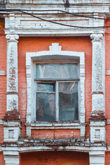Old window in an old abandoned pink administration building in Vinnytsia, Ukraine