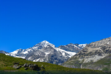 Swiss Alps peaks and ridges covered in snow in Summer. 