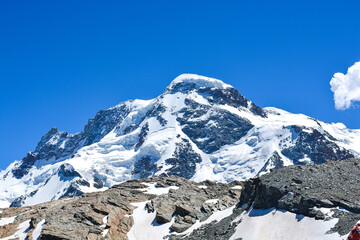 Swiss Alps peaks and ridges covered in snow in Summer. 