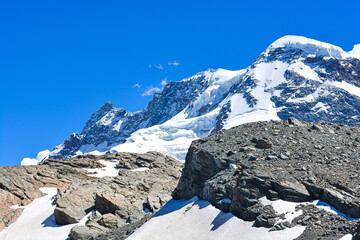 Swiss Alps peaks and ridges covered in snow in Summer. 