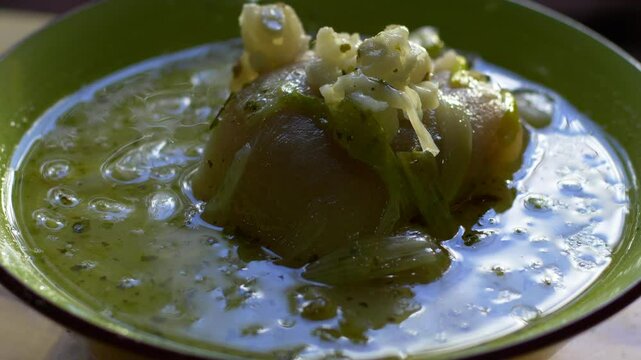 Dish called caldo de pata de vaca served on a plate. A delicate dish typical of the Ecuadorian highlands