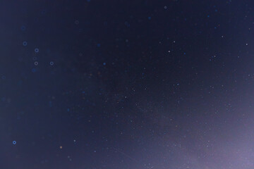 A tranquil night sky filled with numerous stars, showcasing the beauty of the cosmos. The deep blue background highlights faint constellations and the vastness of space.