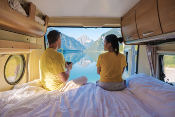 Enjoying serene mornings with a stunning view in Plansee Austria from a cozy camper van