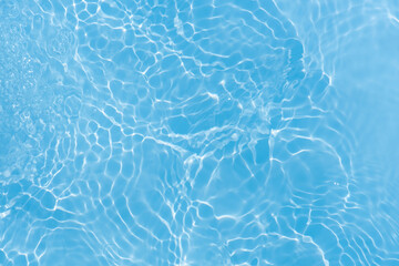 Blue water with ripples on the surface. Defocus blurred transparent blue colored clear calm water...