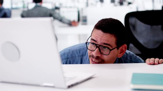 Hiding Behind Desk In Office