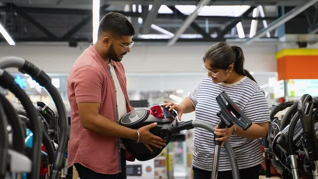 Young Indian couple shopping for a vacuum cleaner on Black Friday