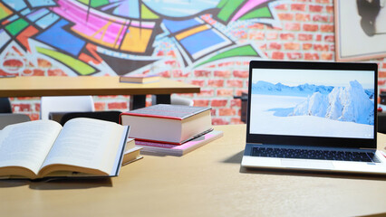 open books and laptop on the table