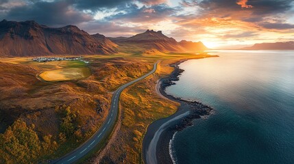 Fototapeta premium Aerial View of a Winding Road Along the Coastline During Sunset