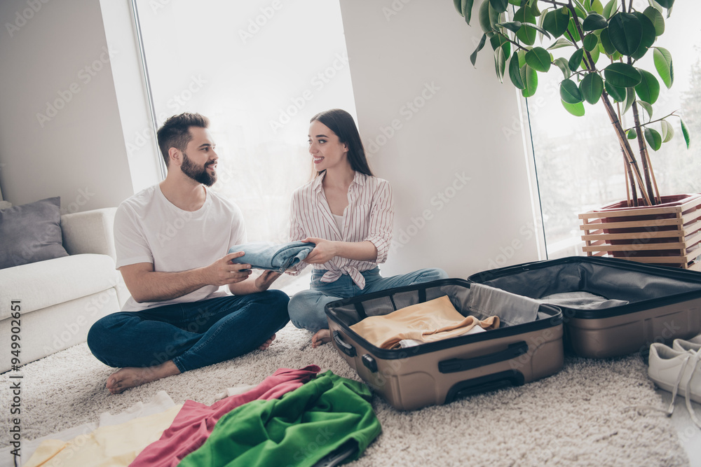 Wall mural Full size photo of two people pack suitcase prepare travel living room flat indoors