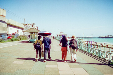A group of people walking in a line on a promenade