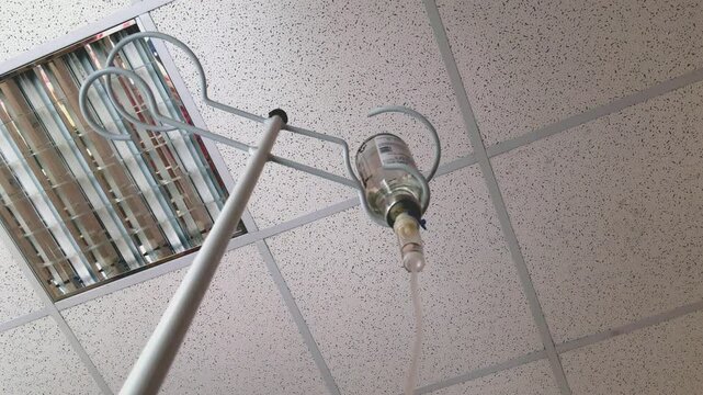Intravenous infusion drops. During the procedure, the liquid is in the vial. Drip administration of saline solution during hospital treatment. Soft focus. 