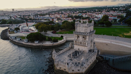 An aerial drone image of the iconic Belém Tower in Lisbon, Portugal, set against the serene...