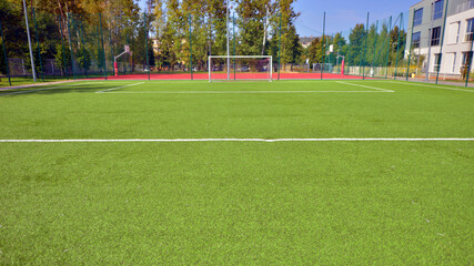 Artificial football turf with a white dividing line. Texture of Perfect green lawn on the football field. 