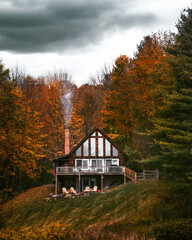 Forest Cabin in Autumn in New England. Smoke From Chimney. Fall Foliage Trees Remote Get Away Off the Grid Forest Camping Vacation Holiday USA Clouds