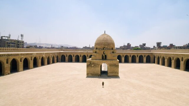 Aerial View Of A Man At Ibn Tulun Mosque Complex On A Bright Sunny Day in Cairo, Egypt.