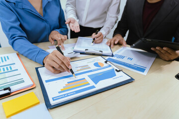 A collaborative office environment where professionals brainstorm, discuss strategy and work together to drive growth, innovation and leadership across business areas.