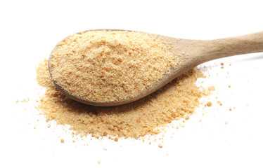 Ground, minced biscuit, pile crumbs in wooden spoon isolated on white, side view