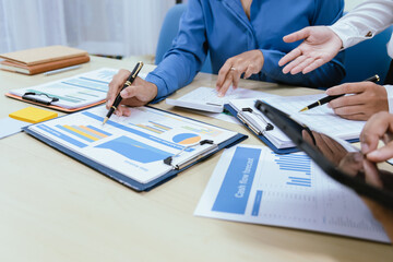 A collaborative office environment where professionals brainstorm, discuss strategy and work together to drive growth, innovation and leadership across business areas.