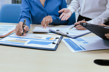 A collaborative office environment where professionals brainstorm, discuss strategy and work together to drive growth, innovation and leadership across business areas.