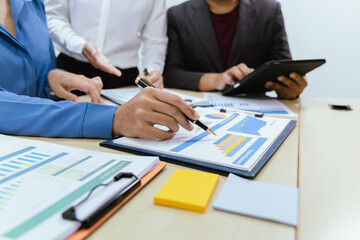 A collaborative office environment where professionals brainstorm, discuss strategy and work together to drive growth, innovation and leadership across business areas.