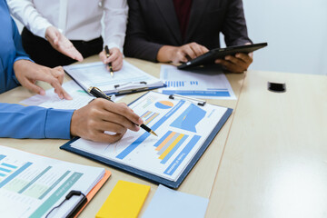 A collaborative office environment where professionals brainstorm, discuss strategy and work together to drive growth, innovation and leadership across business areas.