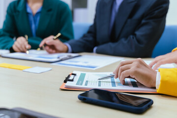 A busy office environment where teams collaborate on creative projects, finance, and marketing strategies using data, charts, and reports, engaging in brainstorming and training sessions to achieve bu