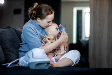 Woman putting on a mask up a nebulizer mask to her child's face