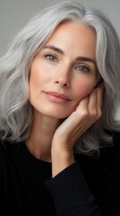 Naklejka premium A close-up of a woman with natural gray hair, styled elegantly, with a focus on the texture and beauty of aging hair, celebrating confidence and individuality