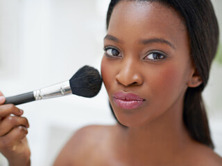 Black woman, makeup brush and portrait with beauty in home, foundation and blush application with confidence. Girl, cosmetic product and glow of self care or powder, aesthetic treatment and grooming.