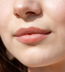 Fototapeta premium Close-up of lips on a girl's face. Macro