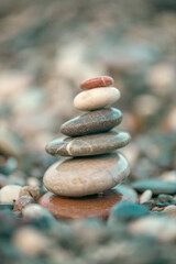 A pyramid of stones on a pebble beach by the sea, the concept of balance, balance, tranquility, relaxation