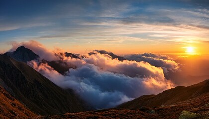 Fototapeta premium In high mountains among clouds, a beautiful sunset can be seen