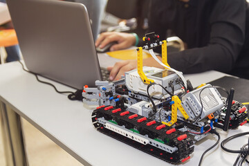 Construction workflow of electronic car with microcontroller at junior robotics club