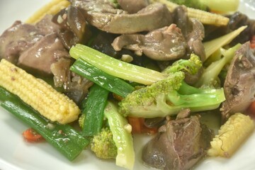 stir fried mixed vegetable with chicken liver and gizzard on plate  