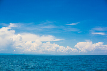 Blue sky with fluffy cloud in sea background