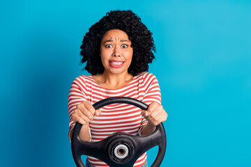 Photo of worried nervous girl wear stylish clothes drive car hold steering wheel isolated on blue color background