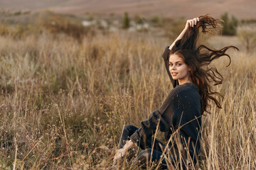 Serene woman in meadow with flowing hair and majestic mountain backdrop