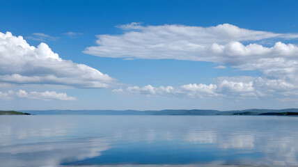 Obraz premium A large calm lake with clouds in the sky