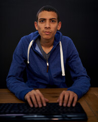 Student, portrait and man typing on keyboard, programming on assignment for university on illegal...