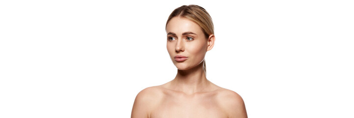 Obraz premium Portrait of attractive young woman with clear, healthy, radiance face and bare shoulders, posing isolated on white background. Concept of beauty, plastic surgery, face lifting, face building. Banner