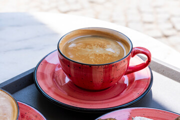 coffee latte on the table in a street cafe outside