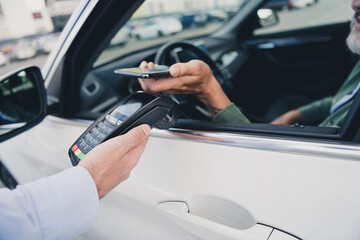 Cropped photo of seniour guy hands arms paying terminal modern device open vehicle window outdoors...
