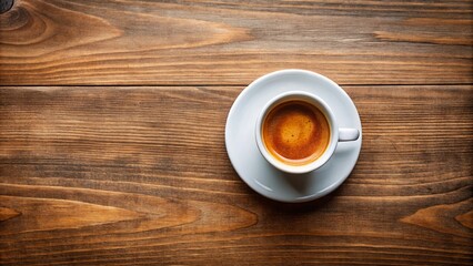 Top view of a cup of freshly brewed espresso on a wooden table