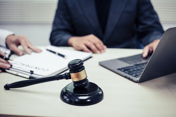 Two lawyers consult in a modern office, presenting compelling arguments and demonstrating their...
