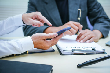 Two lawyers consult in a modern office, presenting compelling arguments and demonstrating their expertise, trying to win a case with their legal acumen and persuasive skills.
