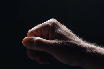 Clenched hand in dark background