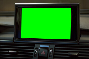 Monitor in car isolated blank screen for navigation maps and GPS rearview camera and parking assistant. Car display with blank green screen for design mock up, copy space.