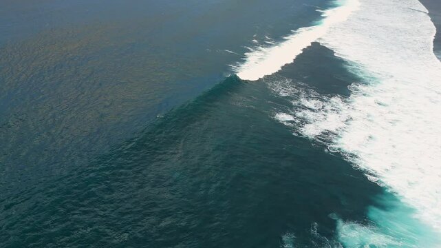 Bali coastline with ocean and perfect swell waves. Drone view of scenic seascape 