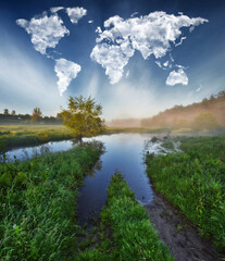 clouds in the form of a world map over a picturesque river. travel and landscape concept. spring meadow